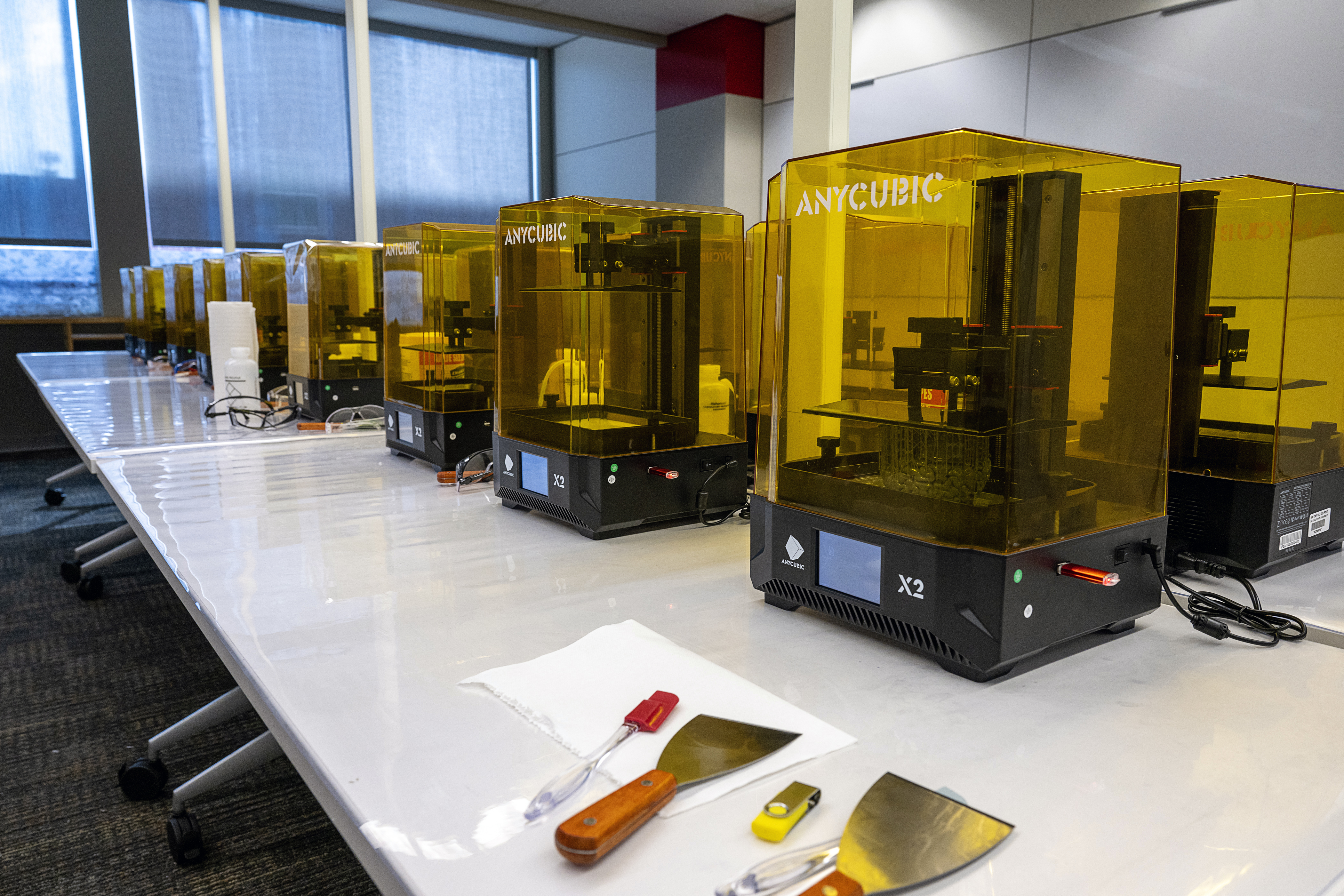 Close up of a row of AnyCubic branded 3D printers within the 3D Printing Lab.