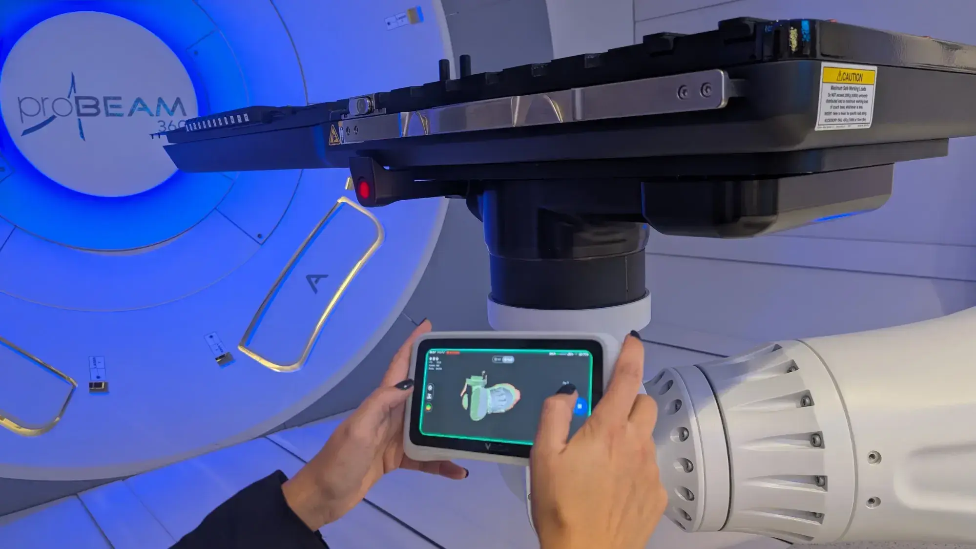 Person scanning proton therapy machine with the Einstar Vega handheld 3D scanner from the EdTech Incubator.